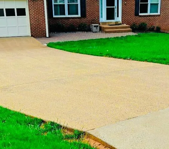 Clean concrete driveway after heated pressure washing
