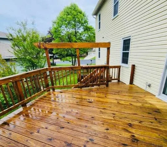 Wooden deck with pergola after washing and staining